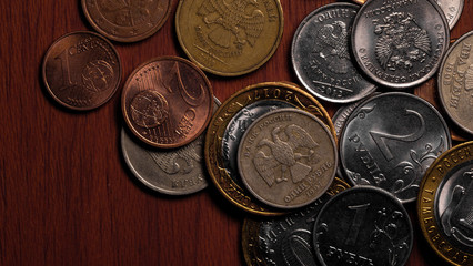 Rubles and Euros. Russian and European currency. Coins of different countries.Closeup.The concept...