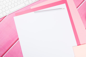 Blank art paper with pencil on bright pink desk 