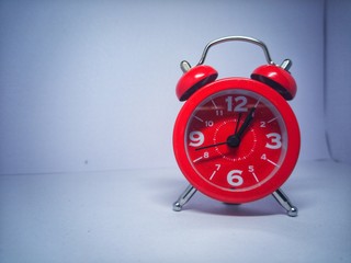 alarm clock on red background