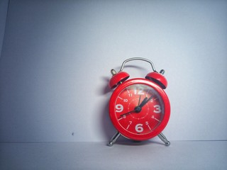 alarm clock on red background