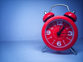 red alarm clock on white background