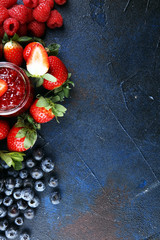 assortment of jams, seasonal berries jelly, mint and fruits and tangerine