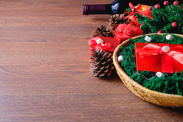 Red gift box in a basket at Christmas and a celebration drink