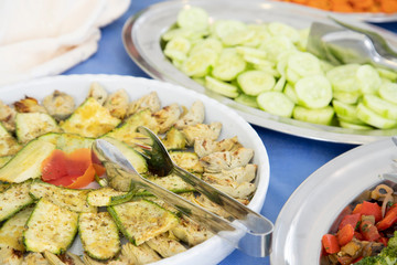 Buffet breakfast in hotel restaurant Tray of zucchini and artichoke hearts