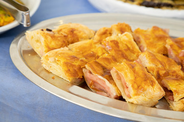 Breakfast buffet in hotel restaurant Pizza tray stuffed with mozzarella and ham