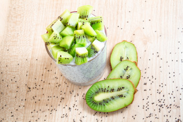 healthy breakfast of chia yogurt and kiwi seeds on a wooden background. copy space