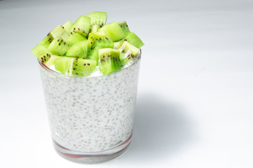 healthy breakfast of chia yogurt and kiwi seeds on a wooden background. copy space