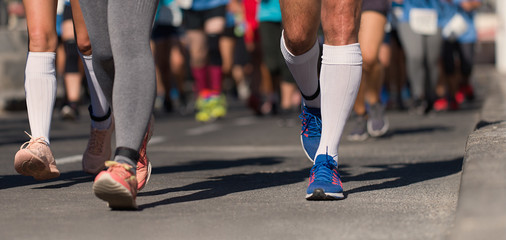 Marathon running race, people feet on city road