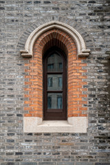 Fototapeta na wymiar Gothic windows and brick walls