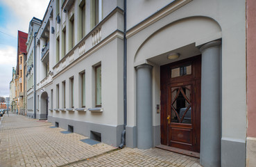 Modern buildings on the city street. Riga, Latvia. Closed wooden door. Art Nouveau architecture.