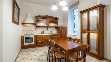 Wooden furniture and kitchen set in luxury kitchen interior.