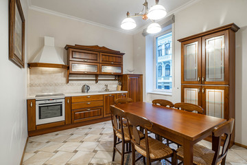 Wooden furniture and kitchen set in luxury kitchen interior.