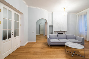 Living room with furniture in apartment. Modern interior in light tones.