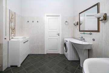 Naklejka na ściany i meble Modern interior of bathroom in light tones with black tile on the floor. Washing machine. White dresser.