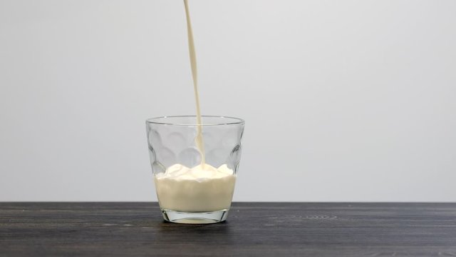 Pouring almond milk in a glass