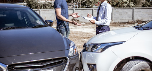 Insurance agents inspect for damage to cars that collide on the road to claim compensation from driving accidents, Insurance concept.