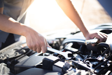 Car mechanic has checked the condition of the engine in wrench, Car repair service concept.