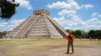 Traveler and the Chichen Itza mayan pyramid in Tinum Municipality, Yucatan State, Mexico.