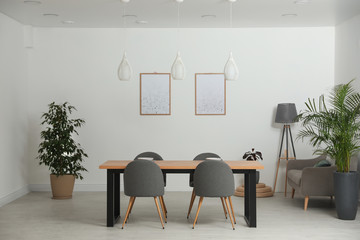 Stylish wooden table in modern room interior