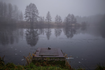Autumn dark lake in fog
