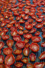Sundried red tomatoes on a grid base in vertical photo