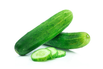 Close-up of Two whole fresh green cucumbers and slices isolated on white background.