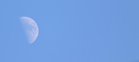 Half moon on blue sky background