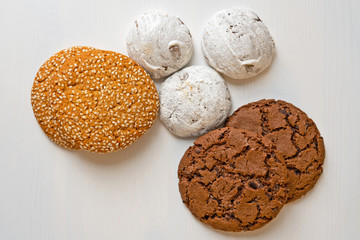 Cookies and gingerbread, mix of spice honey cakes on the white wooden background
