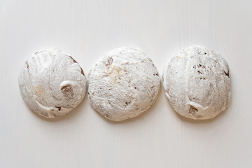 Gingerbread, three spice cakes with icing on the white wooden background