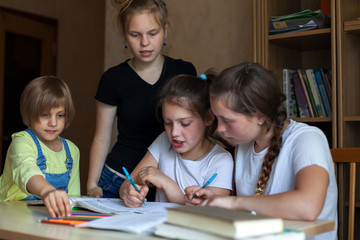 Fototapeta na wymiar girls at desk with notebooks and books