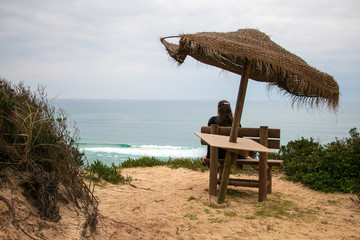 Wooden balcony in the sand with view to the sea