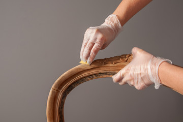 renovation armchair by sanding with sandpaper hardening compound in cracks to seal them on chair's...