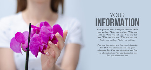 Woman holding purple orchid flower on light gray background