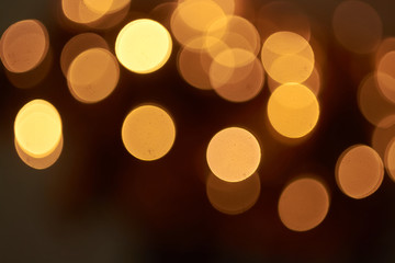 beautiful yellow bokeh lights background on dark