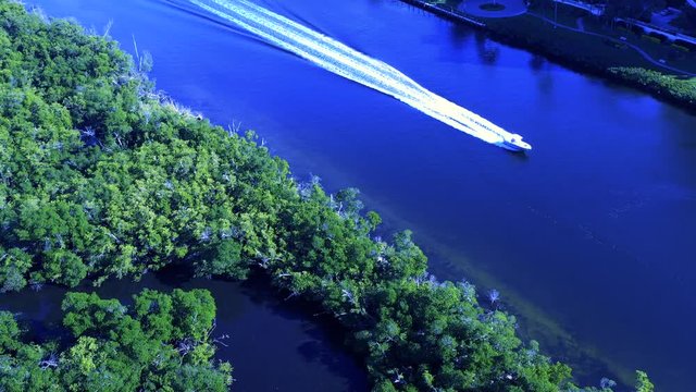 4K boating in the inter coastal waters by an island in tropical waters shot on a hasselblad drone camera