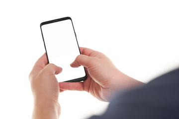 Man hands typing on the black smartphone blank screen with modern frameless design isolated on...