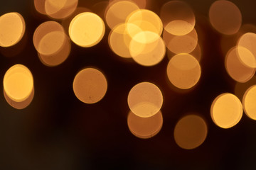 beautiful yellow bokeh lights background on dark