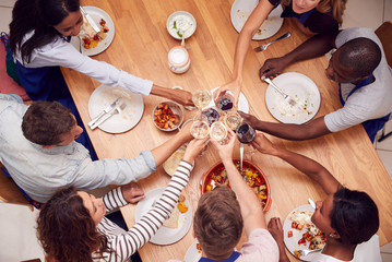 Overhead Shot Of Men And Women Making Toast Eating Meal They Have Prepared In Kitchen Cookery Class