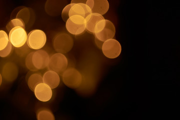 beautiful yellow bokeh lights background on dark