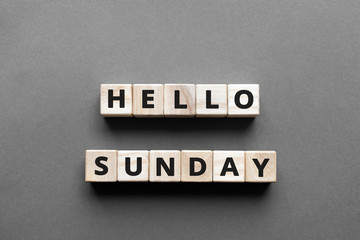 Hello sunday - words from wooden blocks with letters, hello sunday concept, top view gray background © SecondSide