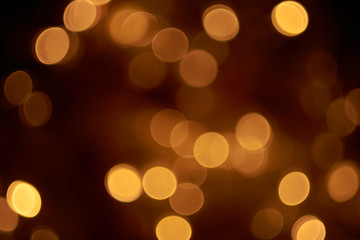 Obraz premium beautiful yellow bokeh lights background on dark