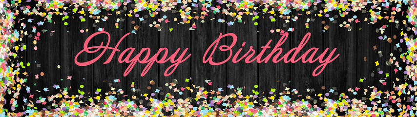 Happy Birthday background panorama banner long - Frame made of colorful confetti isolated on rustic black wooden texture, with space for text