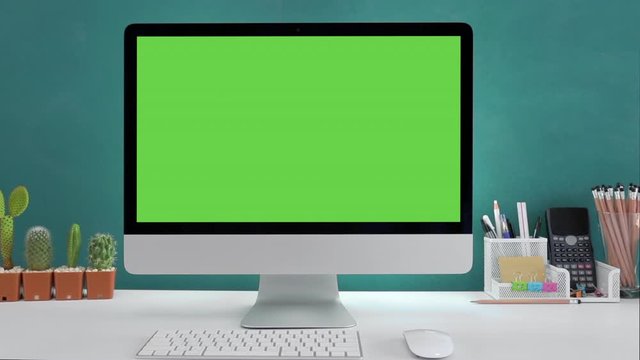 Computer desktop with mock-up green screen white background  in office and  Lovely cactus in brown pot , Zoom shoulder view.