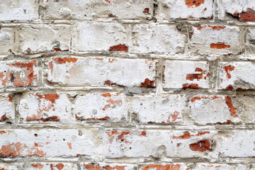 Loft damaged texture, wallpaper and background with painted red bricked wall colored in white. Unusual design, decoration and exterior or interior details concept