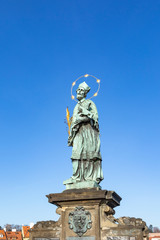 Fototapeta na wymiar Statue of John of Nepomuk on the Charles bridge in Prague