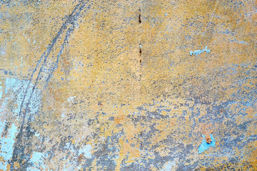 Painted in yellow concrete old damaged texture, wallpaper and background, close-up. Grunge rusty design, decoration and exterior or interior details concept