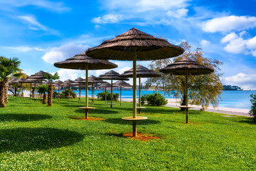 Beautiful coast of Porec with parasols on the beach promenade
