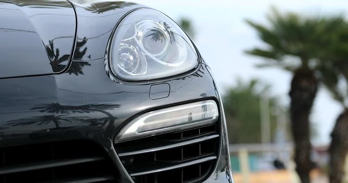 Headlight Of Luxury German Black Sport SUV. Close Up View - DCi 4K Resolution
