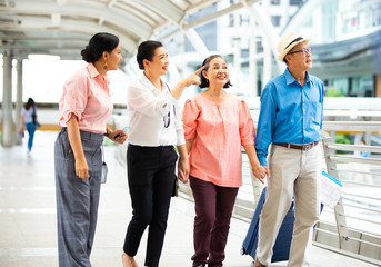 Obraz premium Travel and tourism concept.Group of senior people traveling in the city and looking the map in hand for Shopping Mall Search