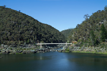 A bridge across a calm lake in Tasmania.